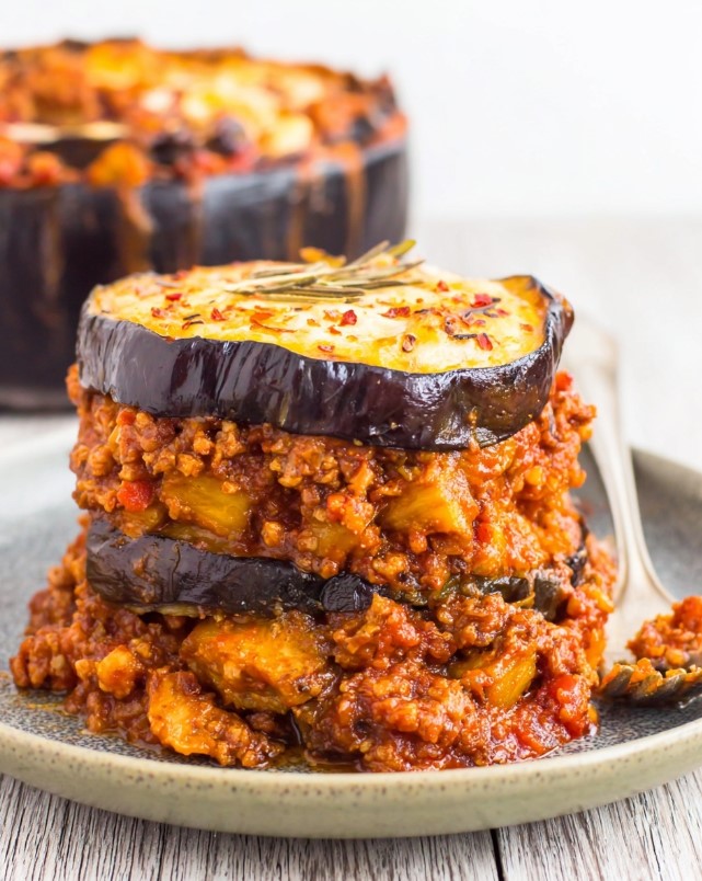A close-up of the golden, baked casserole with distinct layers of eggplant and meat sauce, ready to serve.