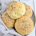 The Ultimate Keto Dinner Rolls (Garlic & Herb Style) Golden baked dinner rolls topped with seed mix, ready for serving.