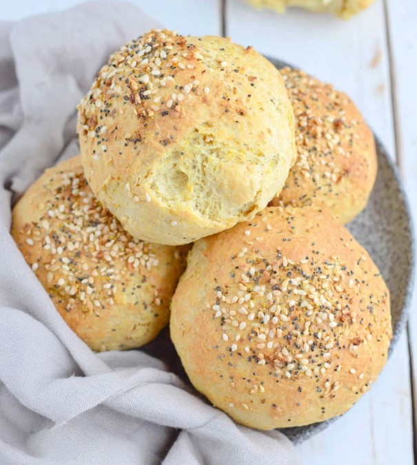 Golden baked dinner rolls topped with seed mix, ready for serving.