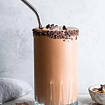 Creamy Keto Chocolate Peanut Butter Smoothie for Busy Mornings A decadent chocolate smoothie served in a glass, garnished with dark chocolate chips.