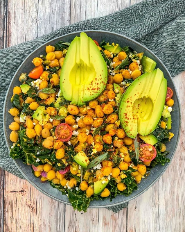 Ready-to-serve bean and vegetable salad after mixing ingredients, seasoning, and garnishing with avocado slices.