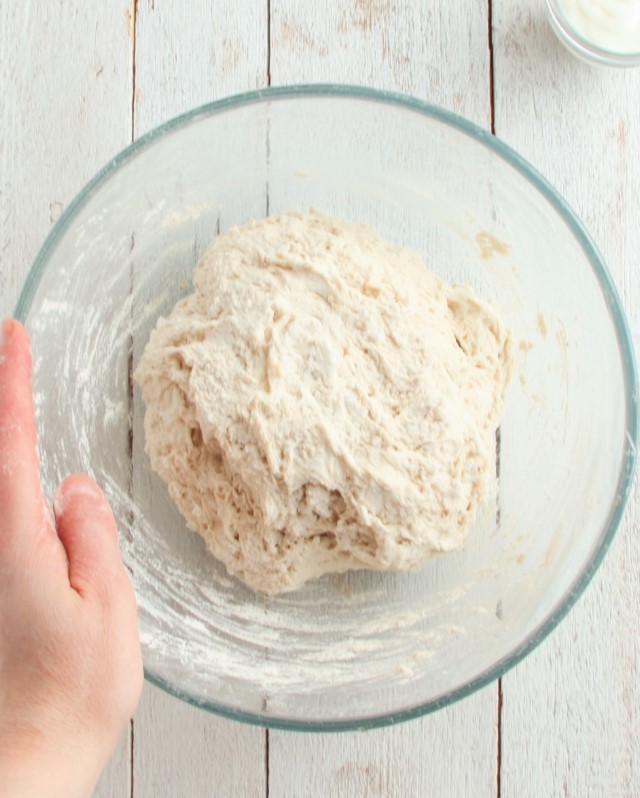 The dough after mixing ingredients, forming a soft dough ball ready for resting or proofing.