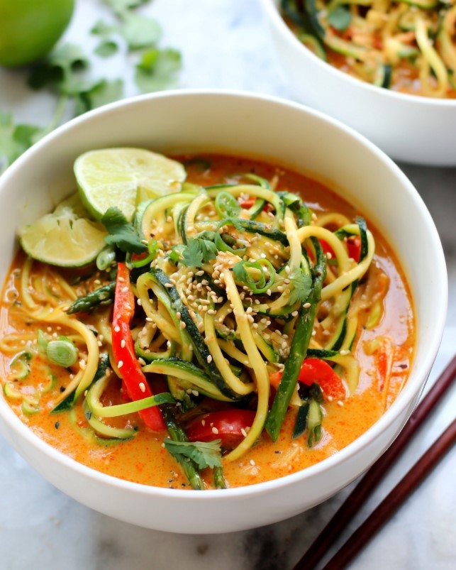 Creamy coconut red curry zucchini noodle bowls - close up detail of zucchini noodles and red peppers in spicy sauce.