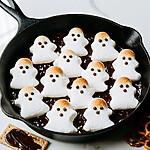 Easy Salted Ghost S'mores Dip in 20 Minutes Cast iron skillet filled with toasted ghost marshmallows and flaky salt served with crackers and pretzels