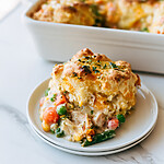 Cheddar Biscuit Chicken Cobbler with a Crisp No-Stir Crust Cheddar Biscuit Chicken Cobbler on a white plate with a crisp golden biscuit crust and creamy vegetable gravy